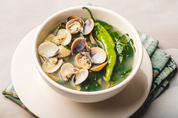 Tinolang Halaan (Clam Soup Recipe)- is a famous and nutritious Pinoy seafood dish with ginger, malunggay leaves and green pepper. 