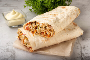 Shawarma with chicken. Shawarma with meat and vegetables. Shawarma in the section. Shawarma is large, cut into two parts.