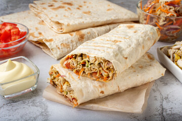 Shawarma with chicken. Shawarma with meat and vegetables. Shawarma in the section. Shawarma is large, cut into two parts.