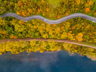Aerial scenery view of winding road and railway beside in autumn fall in Kaunas, Lithuania