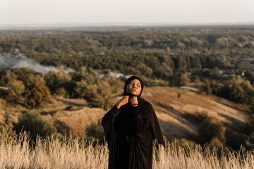 Salah. African woman in black robe pray in god. Islamic religion