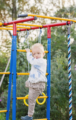 Fototapeta na wymiar little boy on playground on summer day
