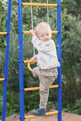 little boy on playground on summer day