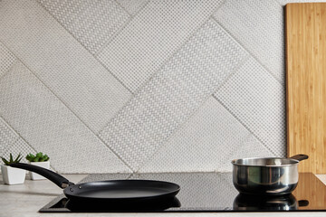 Modern kitchen appliance. Cooking pan on the surface of induction panel with sensor panel