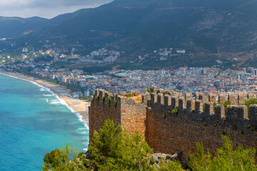 Fototapeta na wymiar Fragments of the fortifications of a medieval fortress on a hill above the Turkish city of Alanya