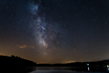 Fototapeta na wymiar Milky way above Neuvic Lake in Correze, France, Summer 2021