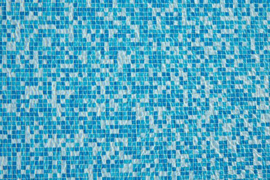 Abstract background of sparkling cool blue water in a swimming pool