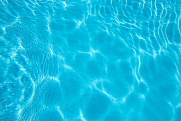 Fototapeta na wymiar Abstract background of sparkling cool blue water in a swimming pool