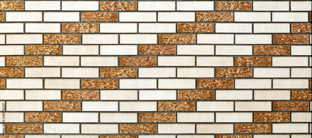 Poster the wall is lined with white and brown decorative bricks. the bricks create a rhythmic diagonal patt