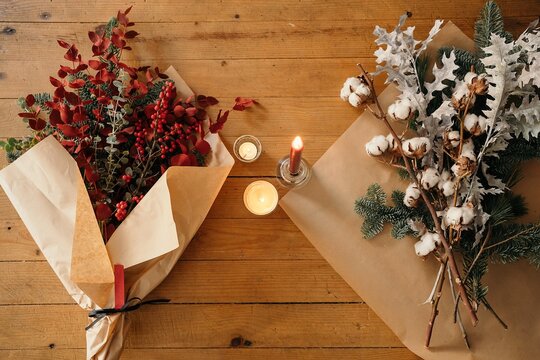 Stylish Christmas bouquet placed on wooden table