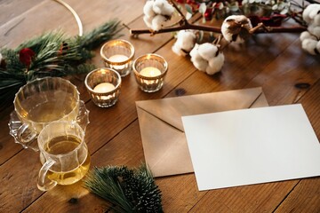 Christmas composition with blank postcard on wooden table