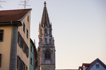 Tower of Konstanz Minster or Konstanz Cathedral near colorful buildings in Germany