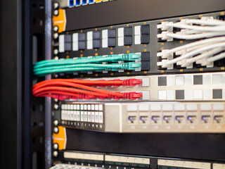Patch panel fragment. Network hardware. Structured cabling systems. Switching equipment close-up. Multi-colored patch panel wires. Automation equipment. Electrical panel of network equipment