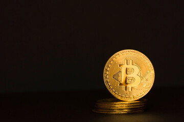 Bitcoin BTC crypto currency gold coins on black background, new virtual money concept. Mining or blockchain technology