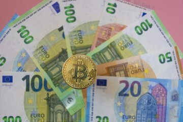The new virtual money Bitcoin BTC crypto gold coin and Euro currency, selective focus