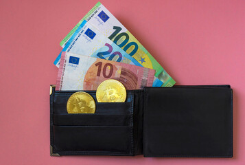 Black leather wallet with Euro currency and Bitcoin BTC crypto gold coins, new virtual money concept. Mining or blockchain technology