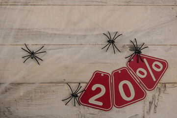 twenty percent discount on Halloween background-price tag on a rustic white wooden background