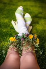 legs in socks with flowers on a green background