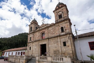 Fototapeta na wymiar Nemocon, Cundinamarca, Colombia. July 2, 2021: Facade of San Francisco de Asís church and blue sky.
