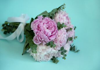 bouquet of pink peonies on a blue background