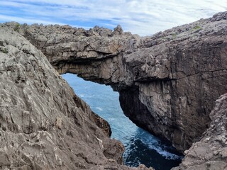 Arch near Las Acacias Beach is one of the few inland beaches in Asturias, Llanes, Spain