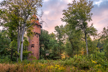 View of the historic water tower with a telecommunications antenna mounted on the roof. The water...