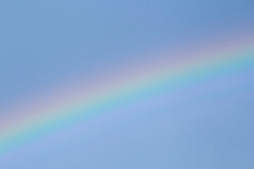 view on rainbow in a blue sky