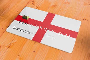 Plastic credit or bank debit card with country flag of England national banking system isolated on wooden table close up concept 3d rendering image