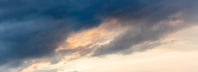 Naklejka na ściany i meble Dark clouds in the sky at sunset