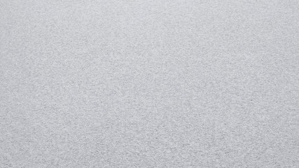 Uniform snow cover. Snow texture on a flat plot of land