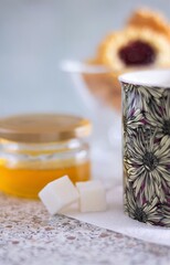 Closeup cup of tea cubes sugar and honey in a jar sweet food eat yummy natural healthy organic beverage delicious breakfast morning nobody