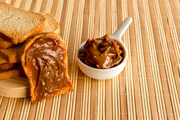 Toasted bread with dulce de leche on breakfast table.