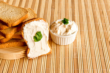 Toasted bread with ricotta cream on breakfast table.