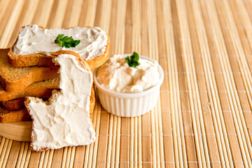 Toasted bread with ricotta cream on breakfast table.