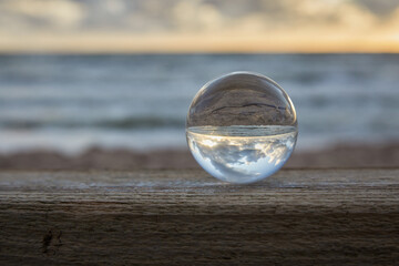 Magic sphere. Fortune teller, mind power concept. Crystal Ball reflecting water and sky.