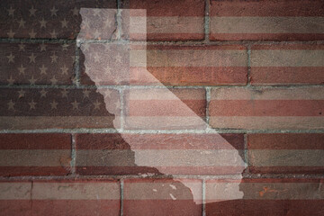 map of california state on a painted flag of united states of america on a brick wall