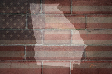 map of georgia state on a painted flag of united states of america on a brick wall - obrazy, fototapety, plakaty