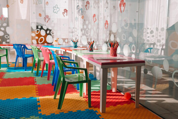 Chairs, table and toys. Interior of kindergarten