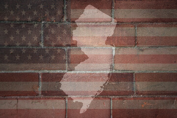 map of new jersey state on a painted flag of united states of america on a brick wall