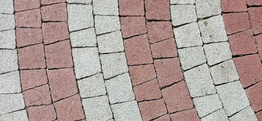 Red and white paving slabs laid in stripes.