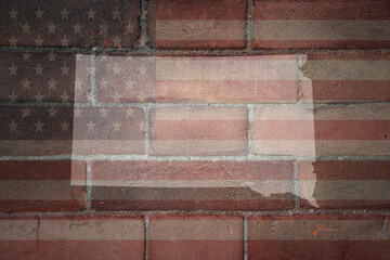 map of south dakota state on a painted flag of united states of america on a brick wall