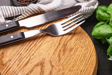 wooden serving board and cutlery fork and knife zero waste meal on the table copy space food background rustic. top view