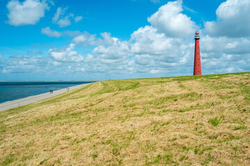 Fototapeta na wymiar The Kijkduin lighthouse, commonly referred to as Lange Jaap, is a lighthouse that stands just north of Fort Kijkduin in Huisduinen, near Den Helder in the province of North Holland.