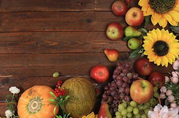 Happy Thanksgiving concept, postcard. Autumn background with seasonal pears, pumpkins, apples and flowers on wooden background, copy space, selective focus. Harvesting, gifts of nature