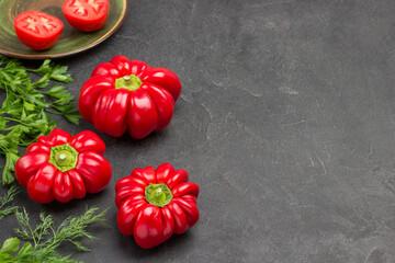 Three red peppers and parsley and dill.