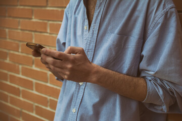 Man Using His Mobile Phone. Unrecognizable Person Using The Cell Phone To Make A Call. Image With Copy Space