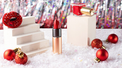 Composition from new year cosmetic-red nail polish bottle on the podium and lipstick.Bright...