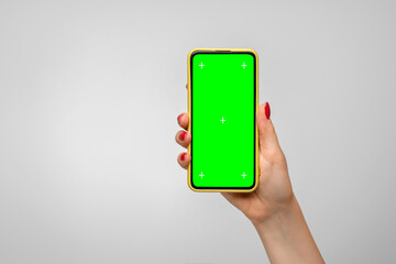 Smartphone in a yellow case with a green screen in a woman's hand