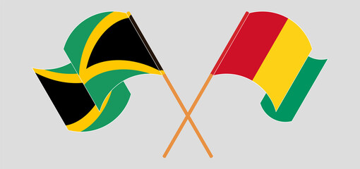 Crossed and waving flags of Jamaica and Guinea