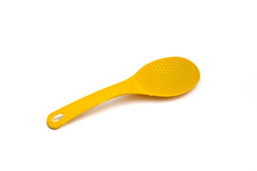 Yellow plastic rice spoon isolated on white background